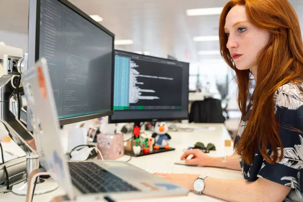 Employee working with cloud software on multiple monitors