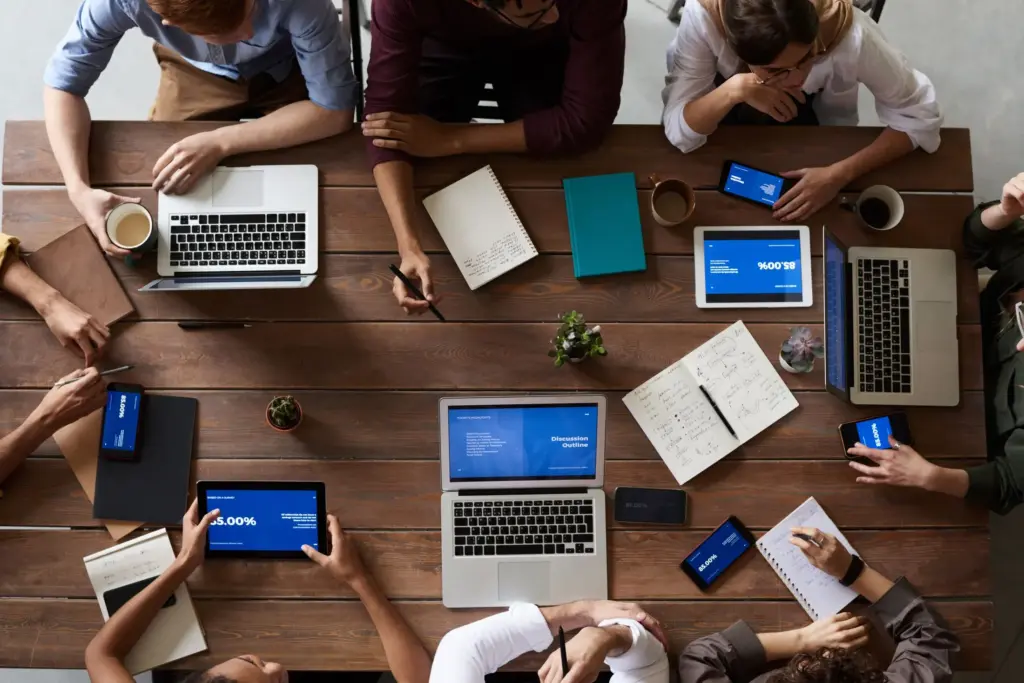Business team working on laptops around a conference table