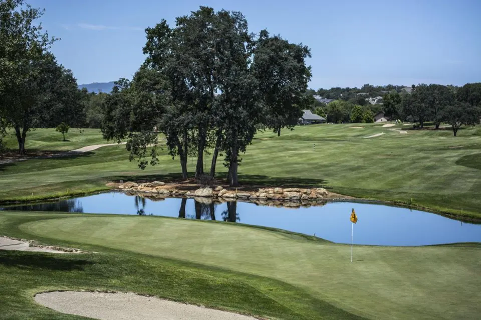 Golf course green with a pond
